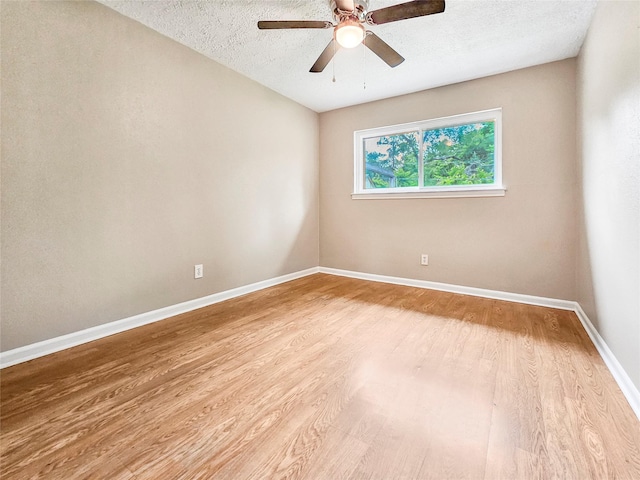723 Pas Trl, Houston, TX 77336 - unfurnished room with wood finished floors, ceiling fan, baseboards, and a textured ceiling