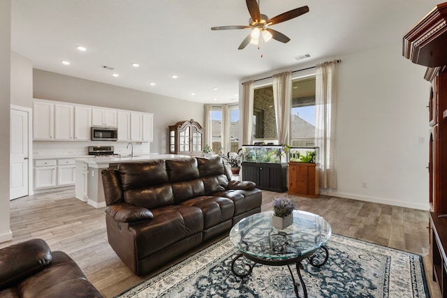 17102 Crimson Crest Dr, Conroe, TX 77302 - living room featuring light wood finished floors, ceiling fan, recessed lighting, and baseboards