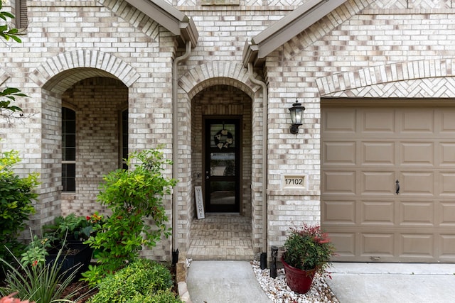 17102 Crimson Crest Dr, Conroe, TX 77302 - view of exterior entry featuring brick siding and a garage