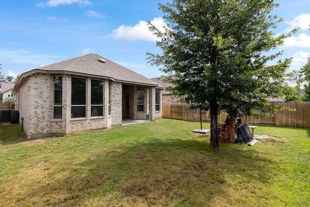 17102 Crimson Crest Dr, Conroe, TX 77302 - back of house featuring brick siding, central AC, and a patio area