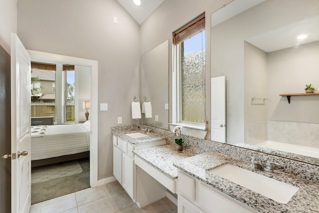 17102 Crimson Crest Dr, Conroe, TX 77302 - ensuite bathroom featuring vanity, tile patterned floors, a garden tub, vaulted ceiling, and baseboards