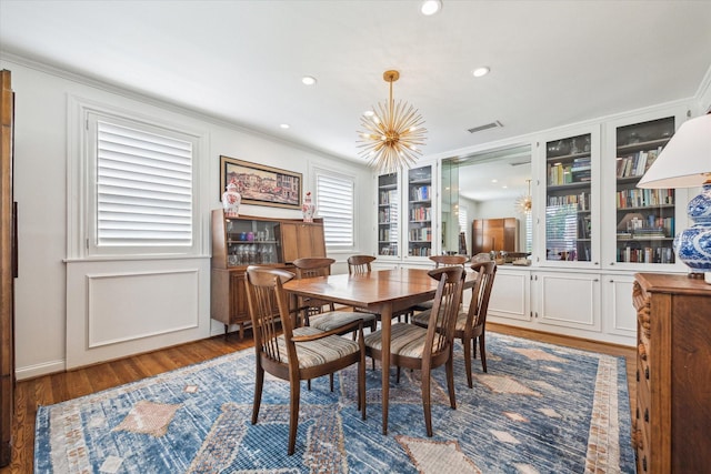2415 Avalon Pl, Houston, TX 77019 - dining room featuring ornamental molding, wood finished floors, a chandelier, built in shelves, and recessed lighting