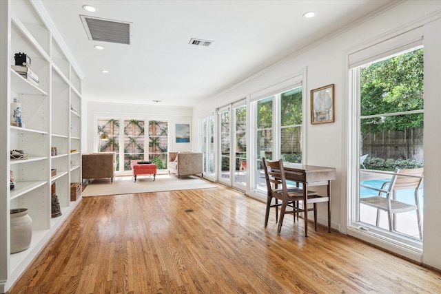 2415 Avalon Pl, Houston, TX 77019 - sitting room with wood finished floors, crown molding, and recessed lighting