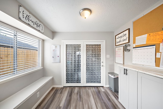 3808 Cottonwood Dr, La Porte, TX 77571 - mudroom with wood finished floors, a textured ceiling, and baseboards
