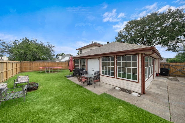 3808 Cottonwood Dr, La Porte, TX 77571 - rear view of property with a patio area, a trampoline, a fire pit, and a shingled roof