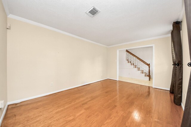12715 Chriswood Dr, Cypress, TX 77429 - spare room with wood finished floors, crown molding, baseboards, and stairway