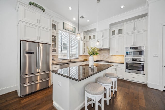 3410 Timbergrove Heights St, Houston, TX 77008 - kitchen featuring appliances with stainless steel finishes, a sink, white cabinetry, a center island, and ornamental molding