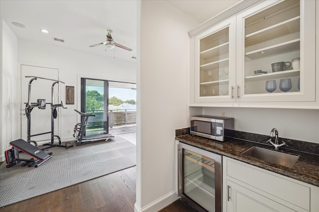 3410 Timbergrove Heights St, Houston, TX 77008 - indoor wet bar with stainless steel microwave, dark wood-style floors, baseboards, beverage cooler, and a ceiling fan