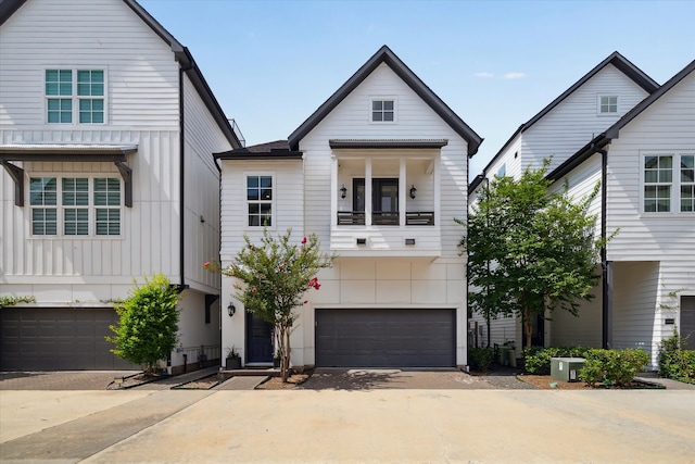 3410 Timbergrove Heights St, Houston, TX 77008 - view of front of home featuring an attached garage, board and batten siding, driveway, and a balcony
