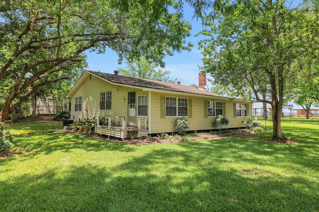 151 Lakeview Cir, Coldspring, TX 77331 - view of front facade featuring a chimney and a wooden deck