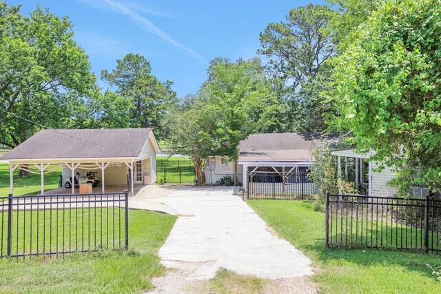 151 Lakeview Cir, Coldspring, TX 77331 - surrounding community with concrete driveway and a carport