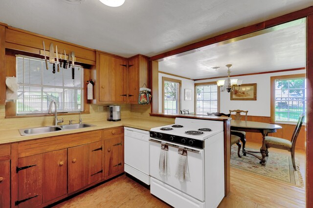 151 Lakeview Cir, Coldspring, TX 77331 - kitchen featuring white appliances, a sink, a chandelier, light countertops, and crown molding
