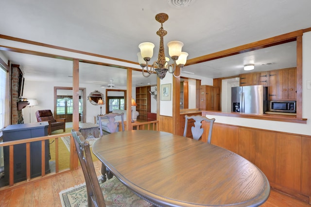 151 Lakeview Cir, Coldspring, TX 77331 - dining space with light wood-type flooring, a chandelier, and a ceiling fan