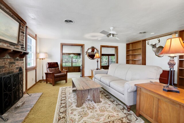 151 Lakeview Cir, Coldspring, TX 77331 - living room featuring light carpet, plenty of natural light, a ceiling fan, and a brick fireplace
