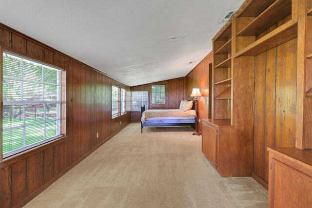 151 Lakeview Cir, Coldspring, TX 77331 - bedroom with wood walls, light colored carpet, and lofted ceiling