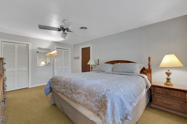 151 Lakeview Cir, Coldspring, TX 77331 - bedroom with multiple closets, light carpet, ceiling fan, and baseboards