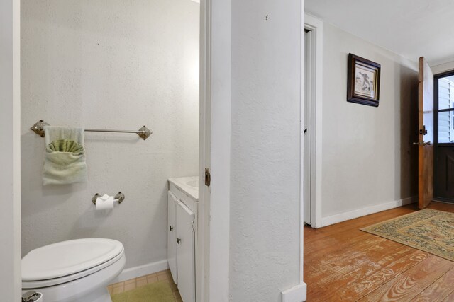 151 Lakeview Cir, Coldspring, TX 77331 - bathroom with vanity, toilet, baseboards, and wood finished floors