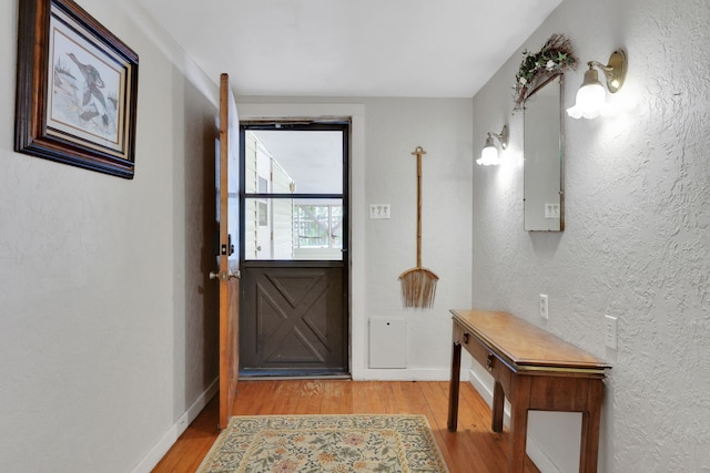 151 Lakeview Cir, Coldspring, TX 77331 - doorway featuring wood finished floors, baseboards, and a textured wall