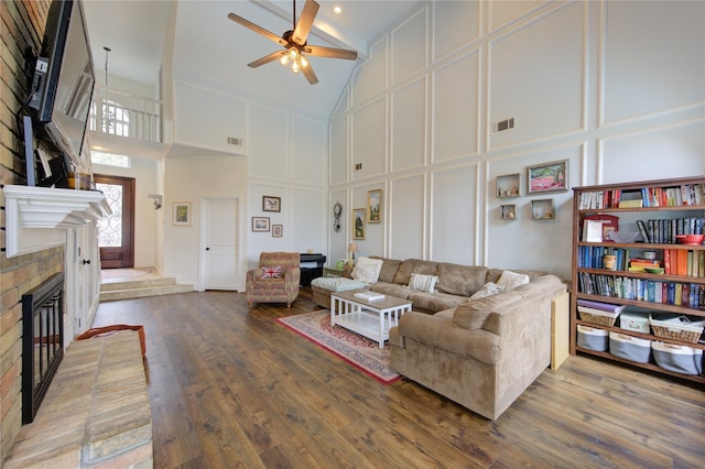 12306 Heatherwick Dr, Cypress, TX 77429 - living room with a decorative wall, high vaulted ceiling, a fireplace, ceiling fan, and wood finished floors