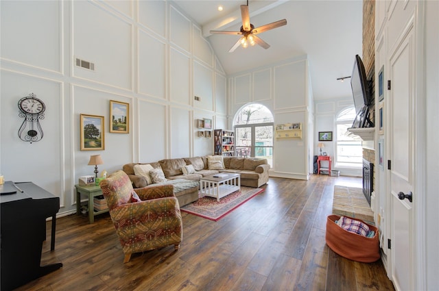 12306 Heatherwick Dr, Cypress, TX 77429 - living area featuring high vaulted ceiling, a decorative wall, ceiling fan, a fireplace with raised hearth, and dark wood finished floors