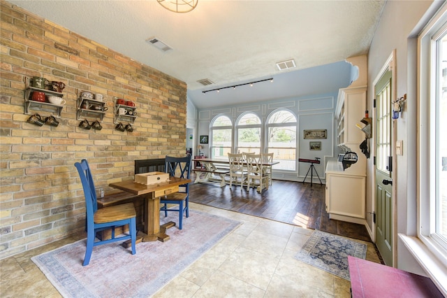12306 Heatherwick Dr, Cypress, TX 77429 - dining area with rail lighting, a textured ceiling, and tile patterned floors
