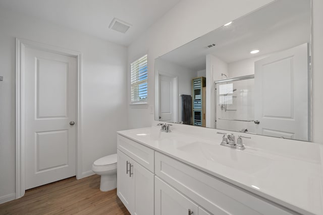 23515 Weir Box Rd, Hockley, TX 77447 - bathroom featuring double vanity, toilet, an enclosed shower, wood finished floors, and baseboards