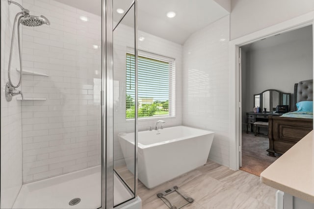 11231 Buchanan Coves Ln, Cypress, TX 77433 - bathroom with a stall shower, a soaking tub, ensuite bath, vaulted ceiling, and recessed lighting