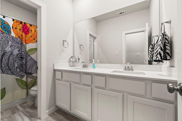 11231 Buchanan Coves Ln, Cypress, TX 77433 - full bathroom featuring double vanity, toilet, and a shower with curtain