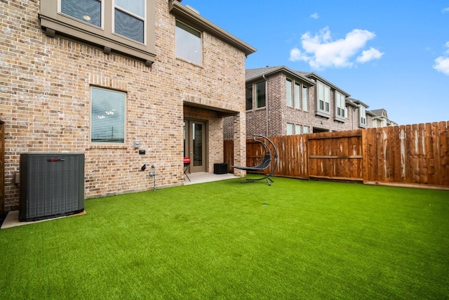 11231 Buchanan Coves Ln, Cypress, TX 77433 - rear view of property with central air condition unit and brick siding