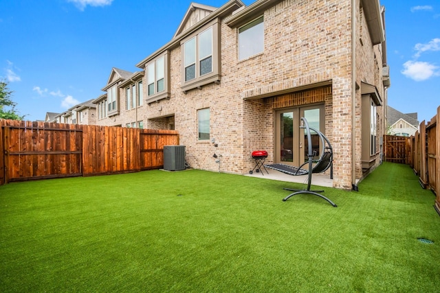 11231 Buchanan Coves Ln, Cypress, TX 77433 - back of property featuring french doors, brick siding, central AC, and a patio area