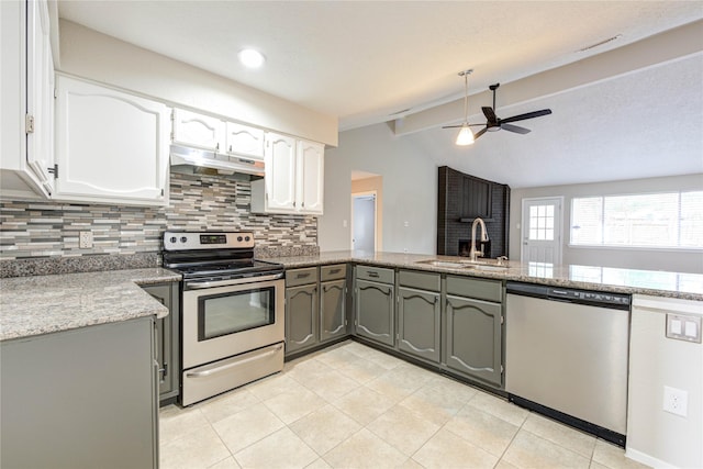 2311 Pepperweed Dr, Houston, TX 77084 - kitchen featuring appliances with stainless steel finishes, under cabinet range hood, a sink, decorative backsplash, and ceiling fan