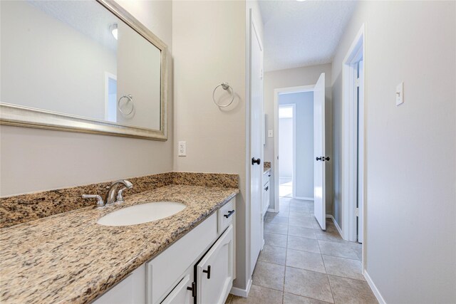 2311 Pepperweed Dr, Houston, TX 77084 - bathroom with vanity, baseboards, and tile patterned floors