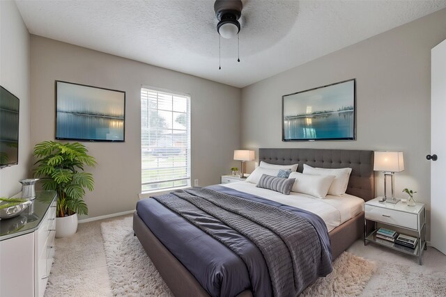 2311 Pepperweed Dr, Houston, TX 77084 - bedroom with light colored carpet, a ceiling fan, and baseboards