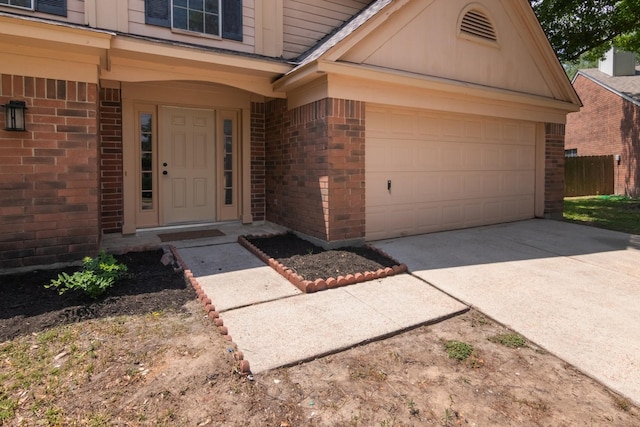 10107 Sands Trail Ct, Houston, TX 77064 - doorway to property featuring brick siding, concrete driveway, and a garage