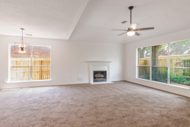 10107 Sands Trail Ct, Houston, TX 77064 - unfurnished living room featuring carpet floors, a fireplace with flush hearth, a ceiling fan, baseboards, and a textured ceiling