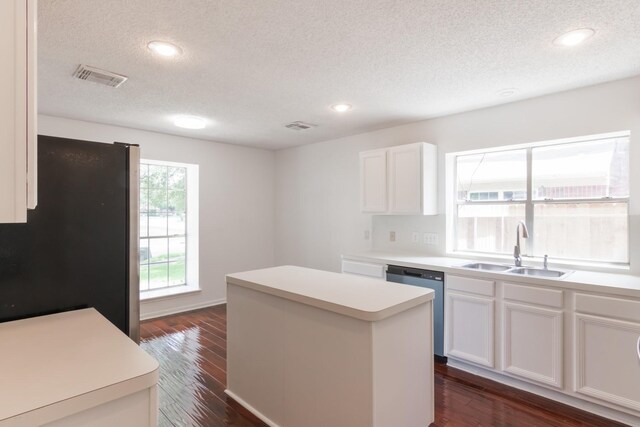 10107 Sands Trail Ct, Houston, TX 77064 - kitchen with a sink, freestanding refrigerator, dishwashing machine, a textured ceiling, and a center island