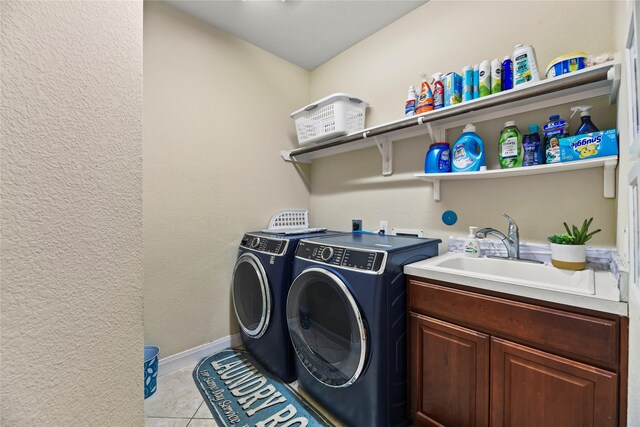 26020 Bassfield Ln, Katy, TX 77494 - washroom with washer and dryer, light tile patterned floors, and cabinet space