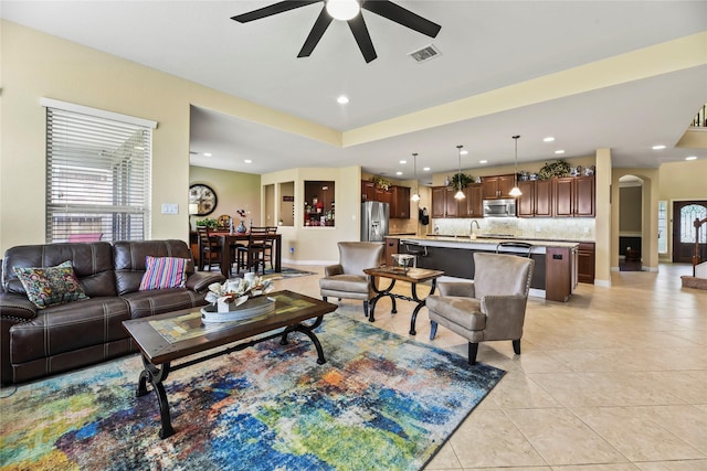 26020 Bassfield Ln, Katy, TX 77494 - living area featuring ceiling fan, arched walkways, light tile patterned floors, and recessed lighting