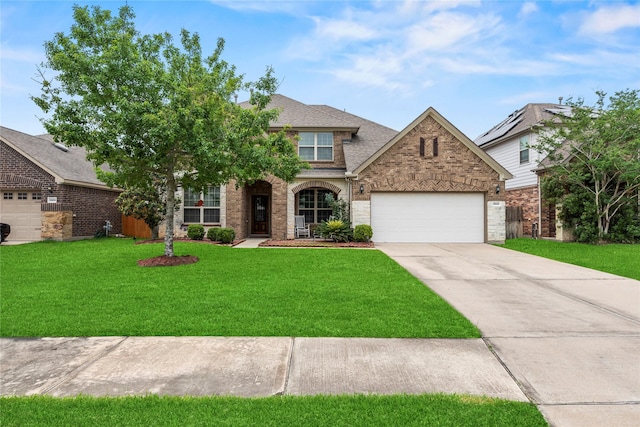 26020 Bassfield Ln, Katy, TX 77494 - view of front of home with brick siding, driveway, a front lawn, an attached garage, and roof with shingles