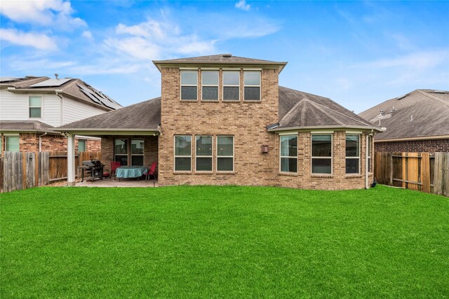 26020 Bassfield Ln, Katy, TX 77494 - back of house featuring a patio, brick siding, and roof with shingles