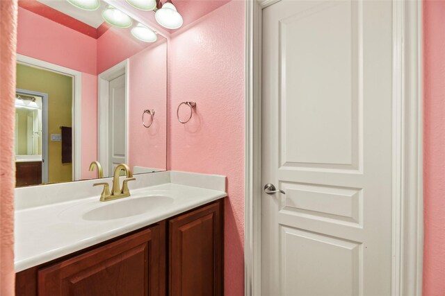 26020 Bassfield Ln, Katy, TX 77494 - bathroom with vanity and a textured wall