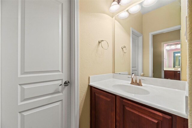26020 Bassfield Ln, Katy, TX 77494 - bathroom featuring vanity and a textured wall