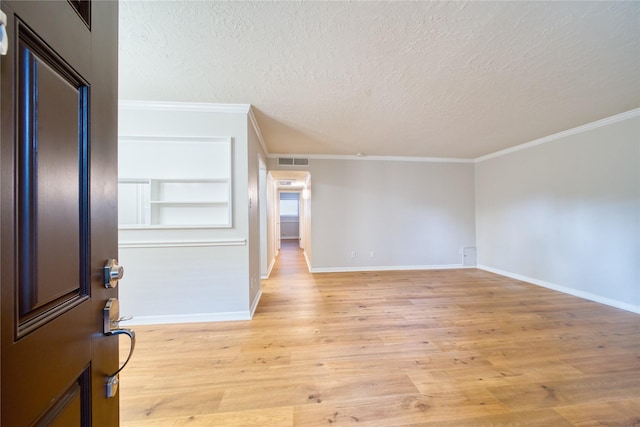 3224 Timmons Ln Unit 157, Houston, TX 77027 - foyer with a textured ceiling, light wood-style flooring, crown molding, and baseboards