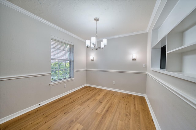 3224 Timmons Ln Unit 157, Houston, TX 77027 - empty room with a chandelier, crown molding, baseboards, and wood finished floors
