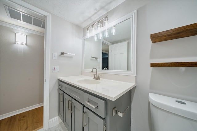 3224 Timmons Ln Unit 157, Houston, TX 77027 - bathroom featuring vanity, toilet, baseboards, and wood finished floors