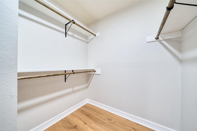 3224 Timmons Ln Unit 157, Houston, TX 77027 - walk in closet with wood finished floors