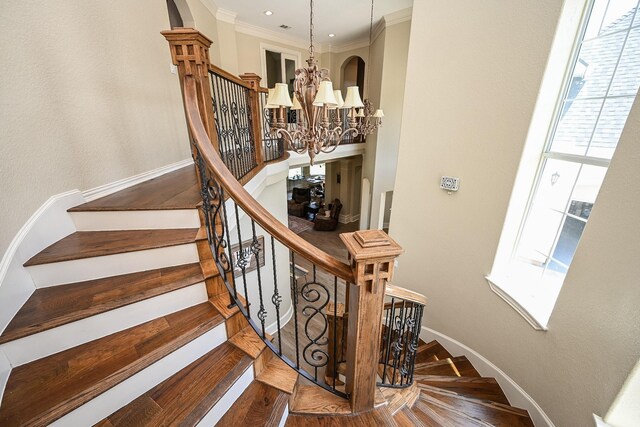 57 Cloverdale Ct, Montgomery, TX 77356 - staircase with a chandelier, baseboards, wood finished floors, and ornamental molding