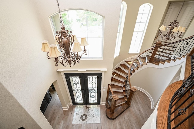 57 Cloverdale Ct, Montgomery, TX 77356 - foyer featuring a chandelier, stairs, wood finished floors, french doors, and a towering ceiling