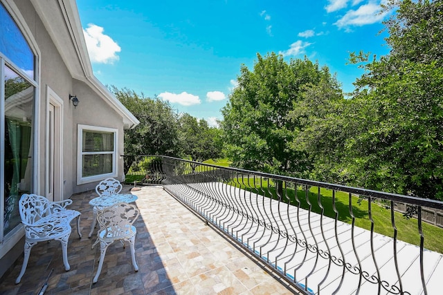 57 Cloverdale Ct, Montgomery, TX 77356 - view of patio / terrace with a balcony and view of scattered trees