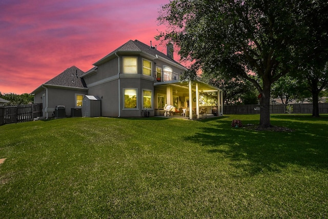 57 Cloverdale Ct, Montgomery, TX 77356 - back of property at dusk featuring a balcony, stucco siding, central air condition unit, and a patio